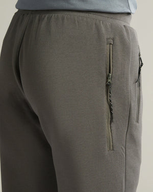 Gray pants with a zipper detail on a neutral background