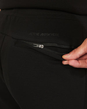 Close-up of a black jacket with 'Active Anywhere' text on a zipper pocket.
