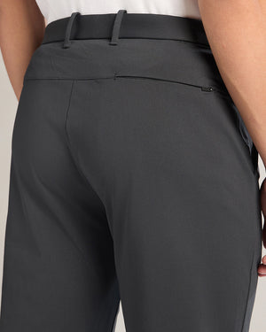 Black pants worn by a person on a light gray background