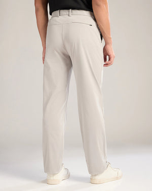 Person wearing beige pants on a plain background