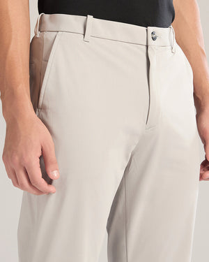 Close-up of beige pants worn by a person on a light gray background