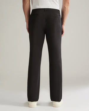 Black pants worn by a person on a plain background