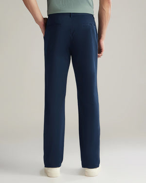 Navy blue pants worn by a person on a plain background