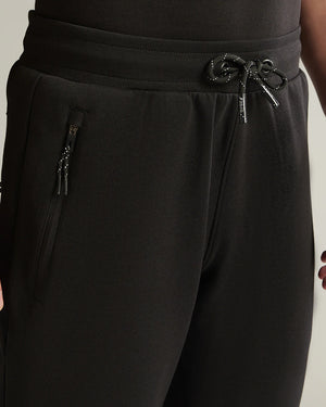Black pants with drawstring waistband on a neutral background