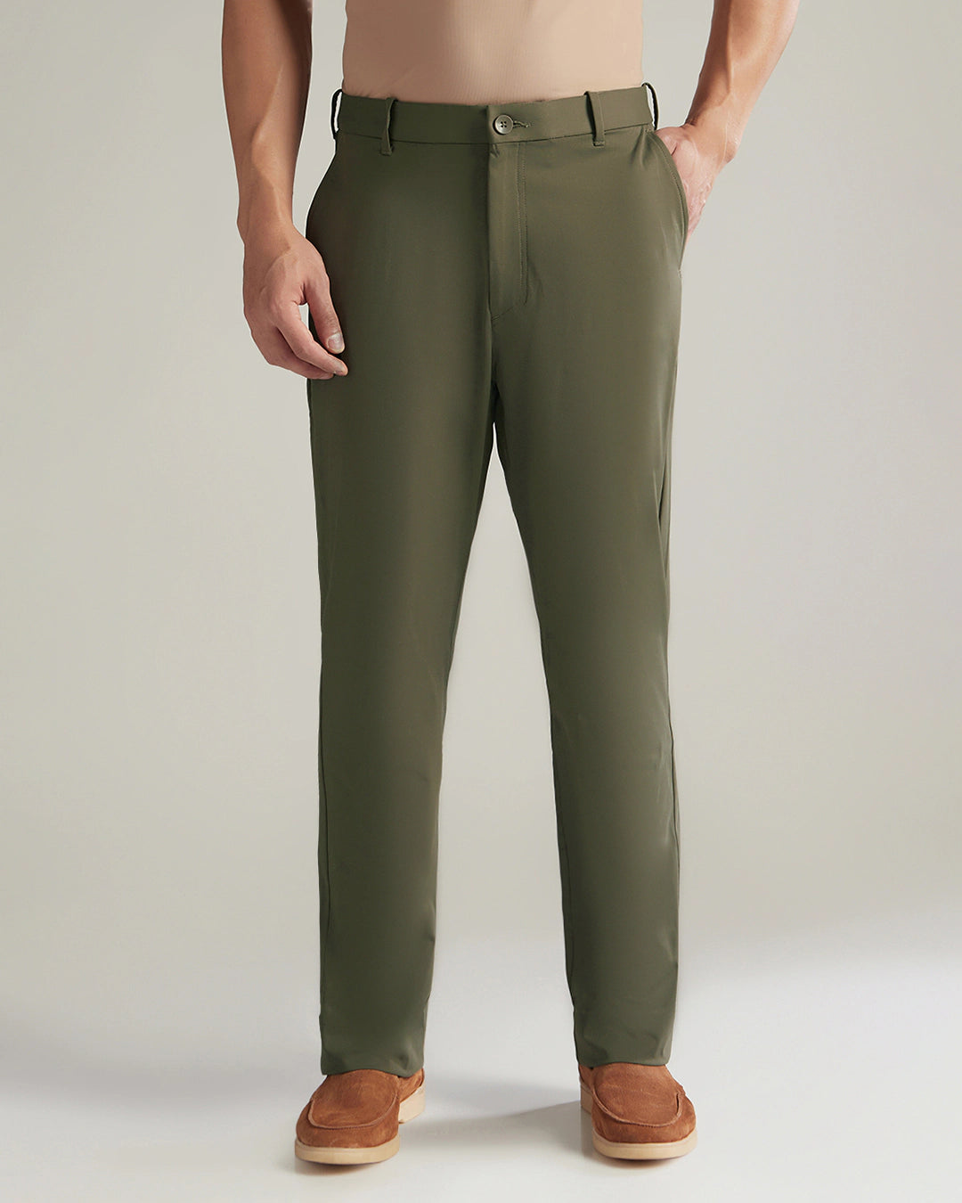 Green pants worn by a person on a plain background