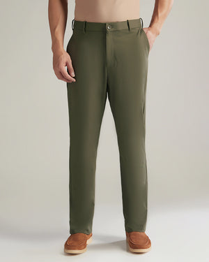 Green pants worn by a person on a plain background
