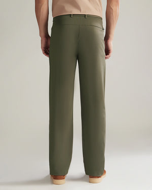 Person wearing olive green pants on a plain background