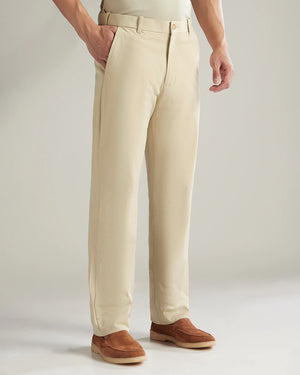 Beige pants worn by a person on a plain background