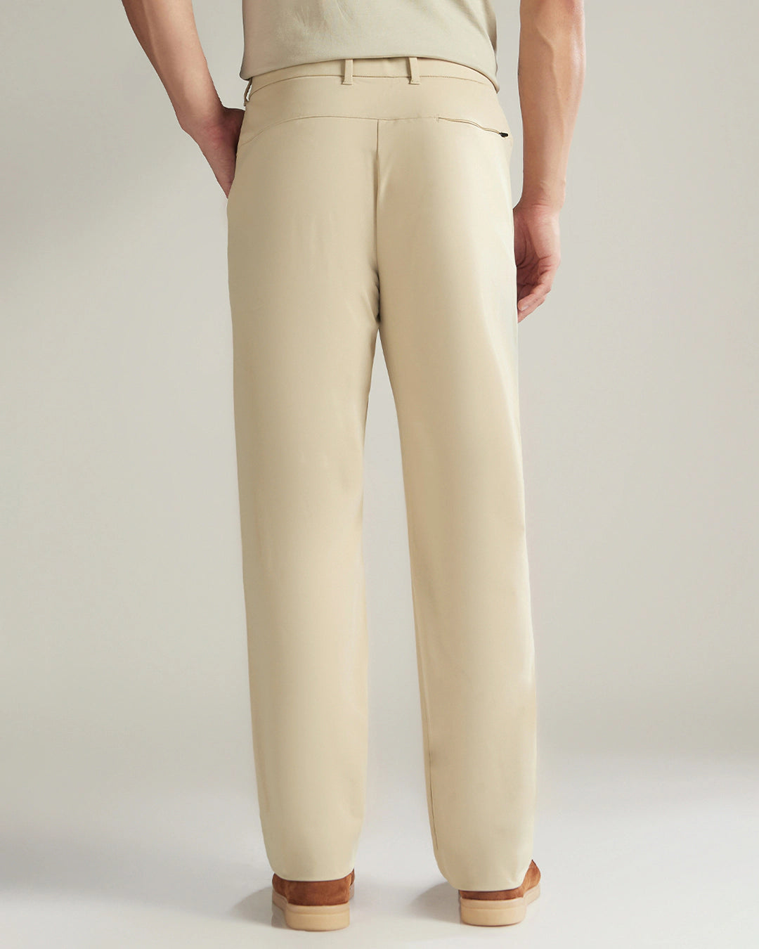 Beige pants worn by a person on a plain background