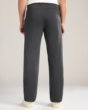 Person wearing dark gray pants on a plain background