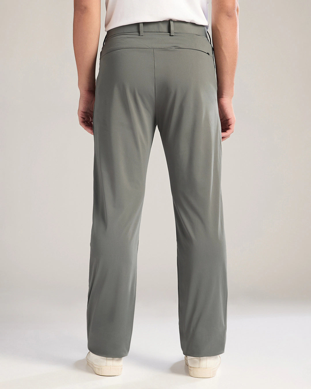 Person wearing green pants on a plain background