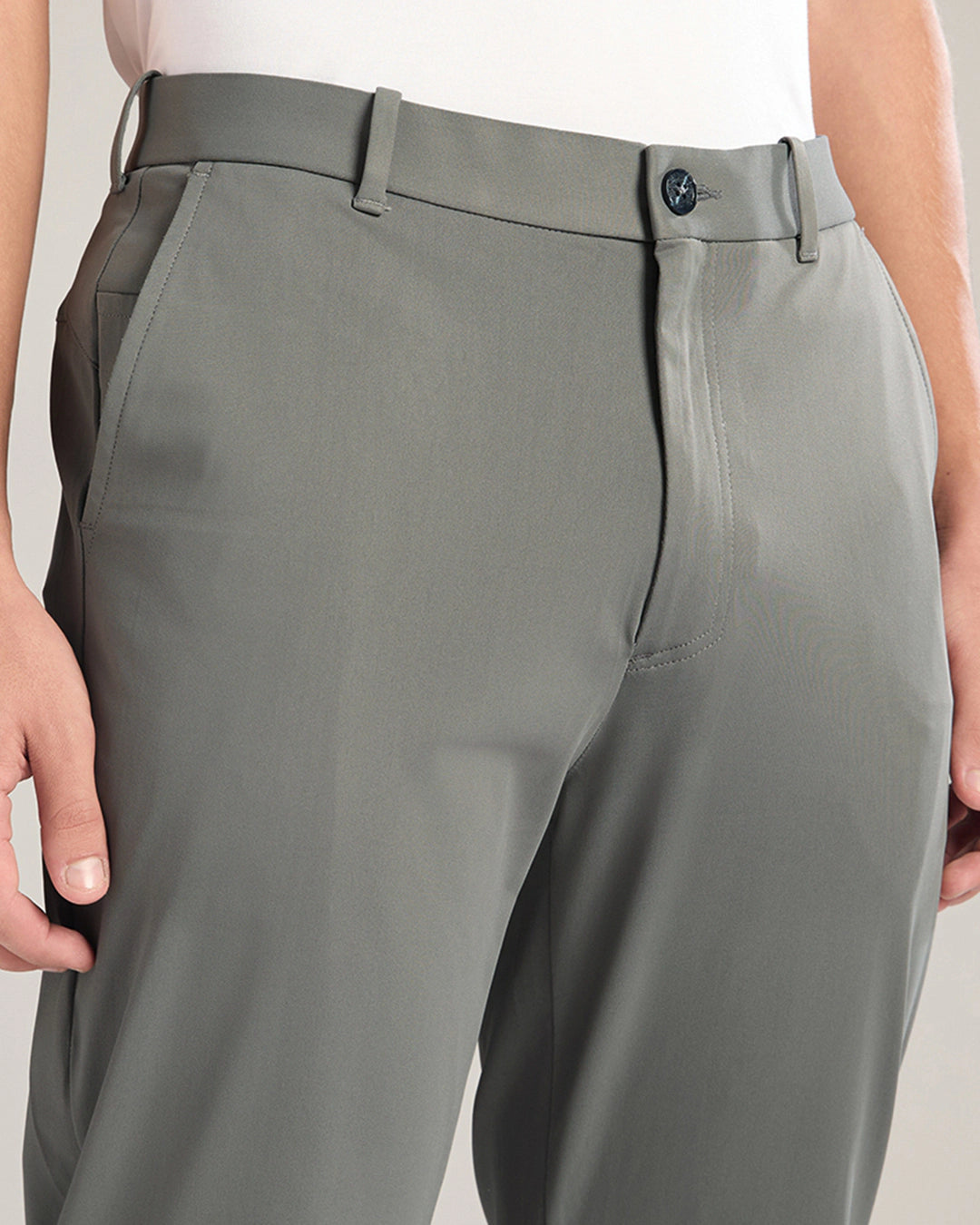 Gray pants worn by a person on a plain background
