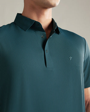 Teal polo shirt worn by a person on a neutral background