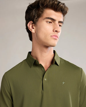 Man wearing a green shirt against a neutral background