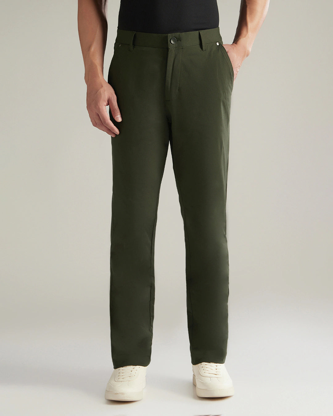 Person wearing green pants on a plain background