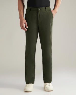 Person wearing green pants on a plain background