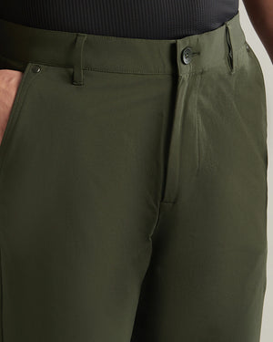 Close-up of olive green pants on a neutral background