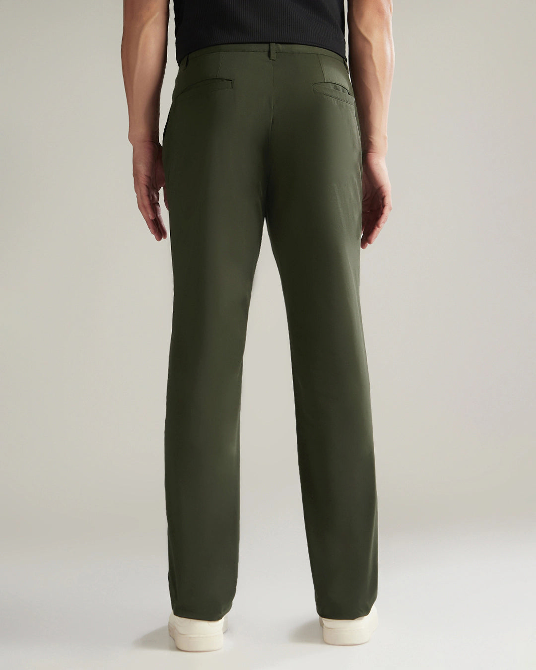 Person wearing green pants on a plain background