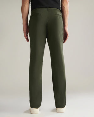 Person wearing green pants on a plain background