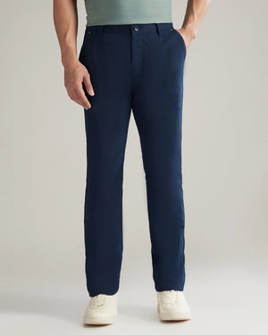 Person wearing navy pants on a plain background